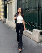 a lady wears a tank top with lace ruffle design and black skinny jeans